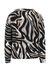 Long-sleeve top featuring a bold black and beige abstract pattern. Made from a soft, textured fabric with a relaxed fit.