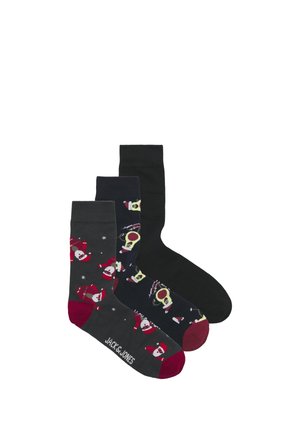 Trois paires de chaussettes : une grise avec des motifs de Père Noël, une marine avec des designs de crânes, et une noire. Bords côtelés, matériau en coton, coupe décontractée.