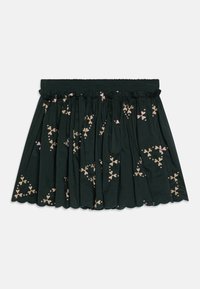 Mørkegrønn bomullsskjørt med elastisk midje, med bølgete kanter og blomsterbroderi i rosa og gulltoner.