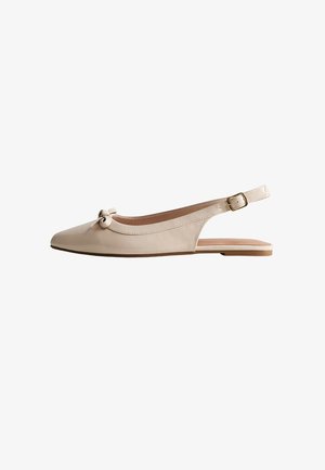 Zapato plano beige de cuero con talón descubierto, puntera puntiaguda, pequeño lazo en la parte delantera y correa ajustable con hebilla dorada.