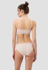 Helles rosafarbenes Lingerie-Set mit einem mit Spitze verzierten Bralette und passender Unterhose, das eine glatte Textur und verstellbare Träger zeigt.