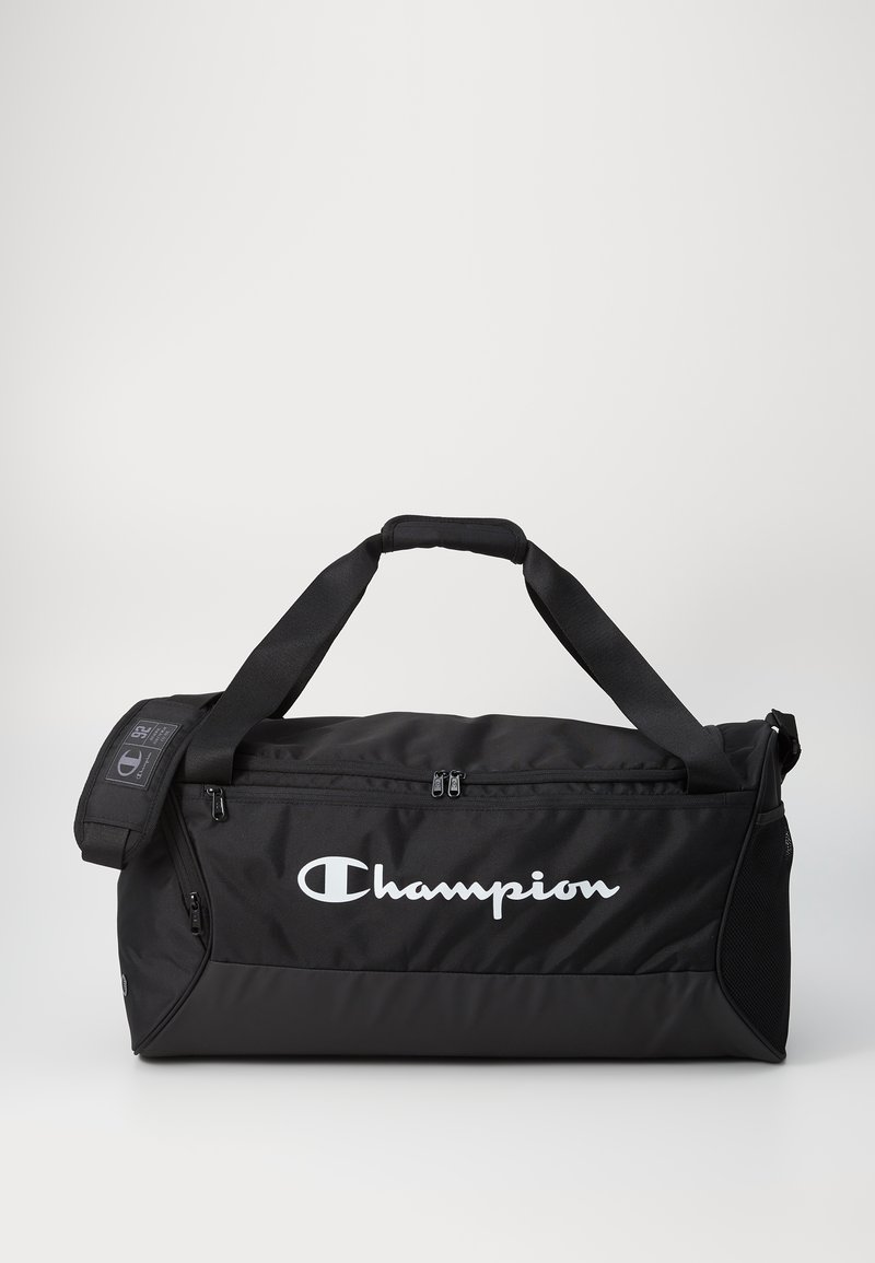 Black duffel bag made of durable material. Features a zipped compartment, padded handles, and white "Champion" logo on the side.