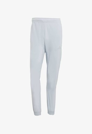 Light grey athletic pants with a slim fit, elastic waistband, gathered cuffs, and subtle logo detail, made from moisture-wicking material.