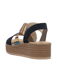 Platform sandals featuring a navy suede upper, patterned fabric straps in blue and earthy tones, and a woven jute sole.