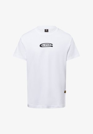T-shirt bianca in cotone con logo nero "G-STAR" al centro, maniche corte, scollo rotondo e un piccolo etichetta gialla in basso a sinistra.