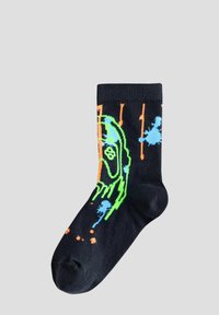 Calza nera di cotone con un design grafico caratterizzato da motivi in verde neon, blu e arancione, che includono schizzi e forme astratte.