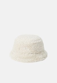 Cream-colored bucket hat made from textured, fuzzy fabric. Features a wide brim and a subtle logo detailing on the side.