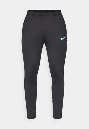 Zwarte sportbroeken van rekbare stof, met een taps toelopend ontwerp, een elastische tailleband en een teal Nike-logo op de linkerdij.