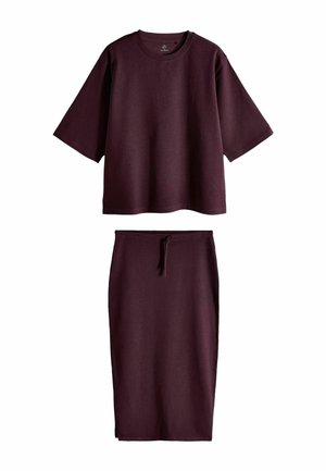 Dark purple set with a loose short-sleeve crew neck top and a high-waisted midi skirt with a front drawstring tie.