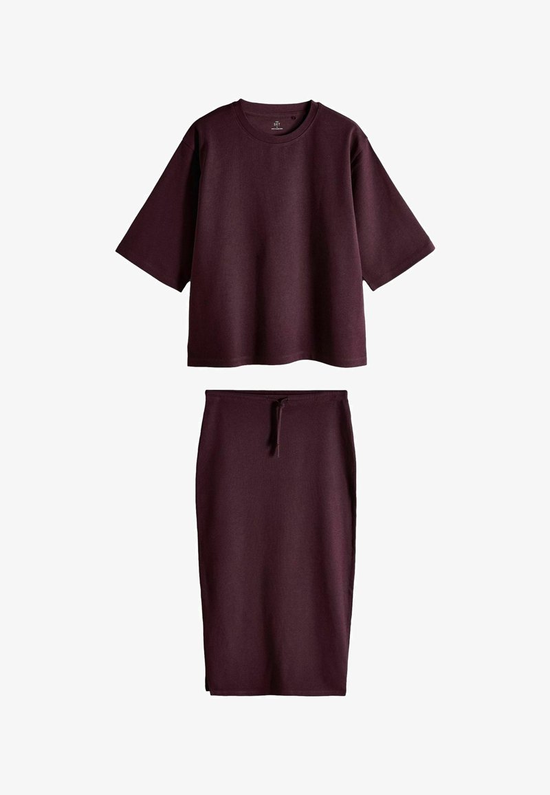 Dark purple set with a loose short-sleeve crew neck top and a high-waisted midi skirt with a front drawstring tie.