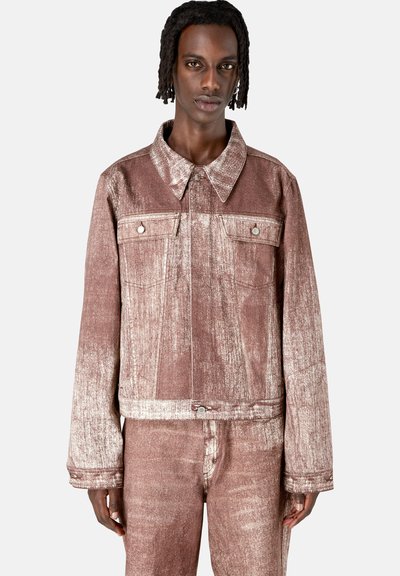 Brown textured denim jacket with a collared neck, two chest pockets, and metallic hardware. Featuring a boxy fit and subtle gradient pattern.
