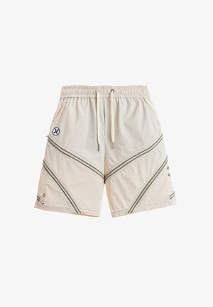 Pantalones cortos beige casual con cintura elástica, cordón, bolsillos laterales, detalles de cremallera diagonal y pequeño logo redondo en el lado izquierdo.