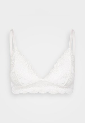 Hvid blonde bralette med bølgede kanter, justerbare stropper og blød tekstur. Designet med en trekantet form og uden bøjler.