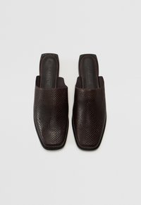 Dark brown slip-on mules featuring a textured, reptile-like leather upper, square toes, and a smooth black outsole with embossed branding.