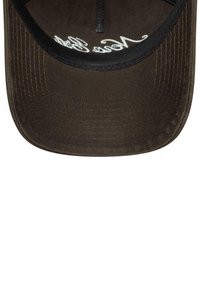 Brown baseball cap with a curved brim, featuring white embroidered text on the underside and a textured, fabric surface.