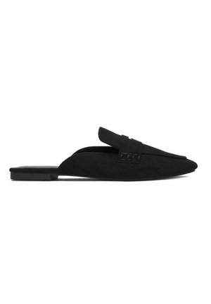 Black suede flat mule with pointed toe, backless design, and decorative strap across the top, shown on a white background.