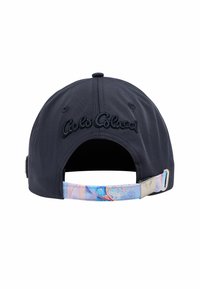 Navy cap with embroidered logo on the back, featuring a colorful patterned strap with a metallic clasp. Structured crown and soft brim.