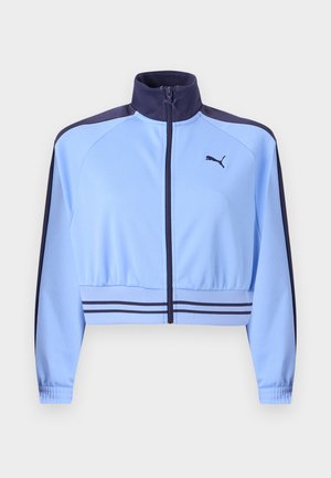 Helehelesinine lühendatud spordijakk tumedasinise krae, õlajuhtmete triipude, vöötriipude, esiluku ja rinnale trükitud Puma logoga.