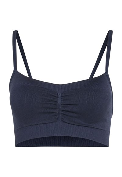 Dark blue seamless bralette with thin adjustable straps and ruched center front detail on a white background.