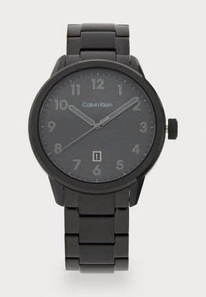 Montre en acier inoxydable noir avec un boîtier rond, un cadran texturé foncé, des index horaires clairs, une fenêtre de date et un bracelet à maillons assorti.