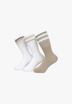 Tre paia di calzini: uno bianco con righe marroni, uno completamente bianco e uno beige con righe bianche. Realizzati in cotone con una texture a costine.