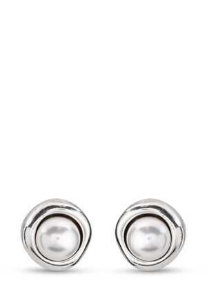 Pendientes de studs en tono plateado que presentan una perla blanca central rodeada por un bisel metálico redondeado y texturizado. Acabado suave con un aspecto pulido.