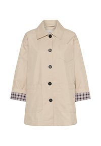Manteau beige à boutons avec col, trois poches avant et doublure à carreaux aux poignets des manches longues.