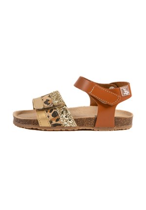 Sandale en cuir brun avec deux brides : l'une avec un imprimé léopard et doré, l'autre en paillettes dorées. La semelle en liège apporte une texture.