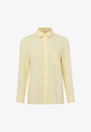 Camicia gialla chiaro a maniche lunghe con bottoni, colletto e taschino singolo sul petto, mostrata su sfondo bianco.