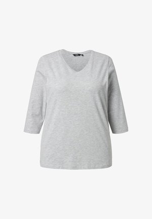 Maglietta grigia a maniche lunghe con scollo a V, realizzata in tessuto morbido, presenta un delicato dettaglio a forma di cuore sul petto e una vestibilità comoda.