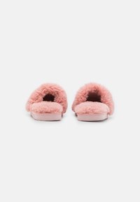 Faux fur pink slippers with a soft texture, open back, and cushioned footbed, featuring a flat sole for comfort and casual wear.
