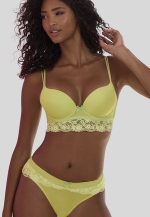 Limettengrüner BH und passender Bikini mit Spitzenrand und Schleifenakzenten. Glatte Textur mit leicht gepolsterten Cups. Verstellbare Träger für einen sicheren Sitz.