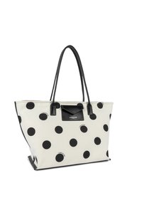 Sac fourre-tout blanc à pois noirs, avec poignées noires et une petite poche avant noire arborant le logo "Lancaster Paris".