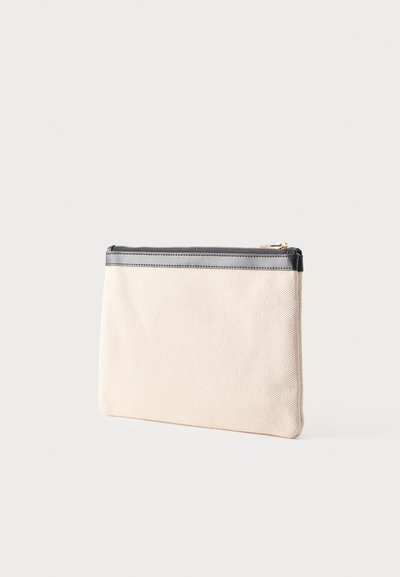 Béžový textilný obal s čiernym lemom a zlatým zipsom na svetlom pozadí.