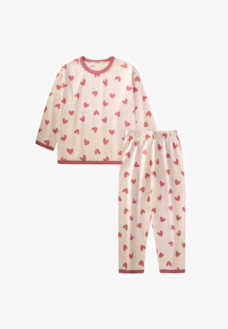 Ensemble comprenant un haut à manches longues et un pantalon en rose clair avec des motifs de cœurs rouges. Contours rouges contrastés au niveau du col et des revers du pantalon. Tissu en coton doux.