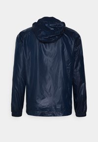 Navy blue waterproof jacket with a hood, elastic cuffs, and a sleek, smooth texture, featuring a simple design without visible fastenings.