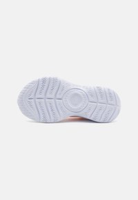 Rubber sneaker sole in white featuring textured traction patterns and a circular logo detail at the center. Sleek, minimal design.