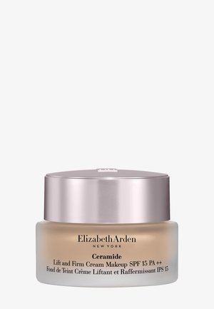 Pot de crème de maquillage Elizabeth Arden Ceramide Lift and Firm avec SPF 15, ton beige et couvercle métallique rose sur fond blanc.