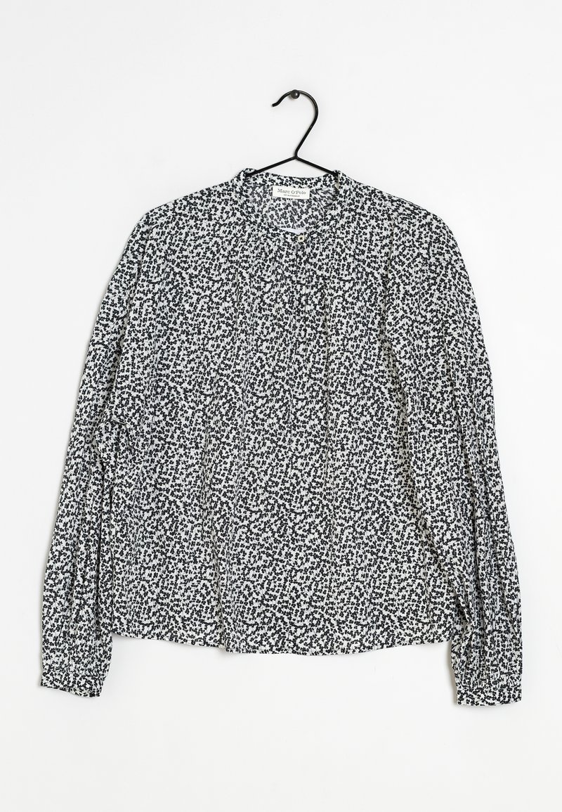 Blusa a maniche lunghe con motivo a pois bianco e nero, tessuto leggero, scollatura rotonda e maniche raccolte con polsini elasticizzati.