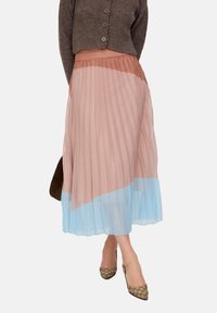 Pleated midi skirt with an elastic waistband, featuring a gradient of blush pink to light blue. Lightweight, sheer material with soft textures.