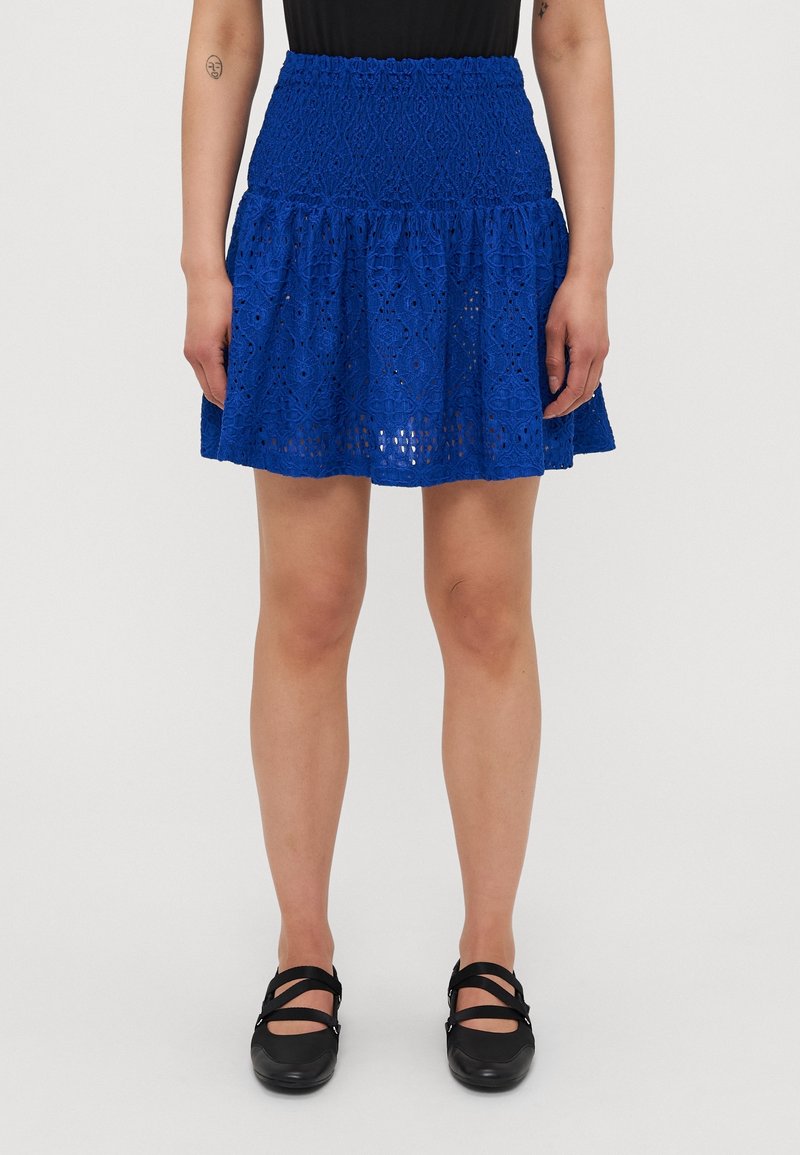 Jupe en dentelle bleue avec un design à volants superposés et une ceinture élastique, mettant en valeur des motifs complexes et une finition texturée.