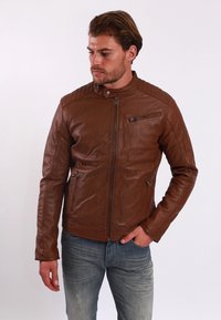 Braune Lederjacke mit Stehkragen, Reißverschluss vorne und gestepptem Schulterdetail. Verfügt über zwei mit Reißverschluss versehenen Taschen und eine taillierte Passform.