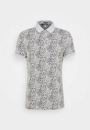 Koszulka polo z krótkim rękawem w czarno-biały nieregularny wzór w kropki oraz z jasnoszarym kołnierzykiem i mankietami rękawów.