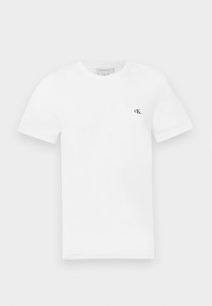 Fehér pamut póló rövid ujjal és kerek nyakkivágással. A bal mellrészen egy kis fekete "ck" logó található. Sima textúra.