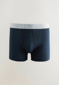 Temno modri bokserice z belim elastičnim pasom, označenim z "NEXT." Imajo gladko teksturo in prilegajoč dizajn s sprednjim žepkom.