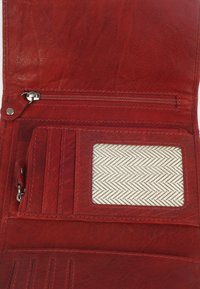 Red leather wallet with a textured surface, featuring a zipper pocket, card slots, and a clear ID window with a herringbone pattern fabric.