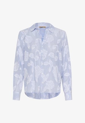 Gaiši zila blūze ar vertikālām baltām svītrām un ziedu rakstiem. Aprīkota ar apkakli, pogām un garām piedurknēm. Gluda auduma tekstūra.