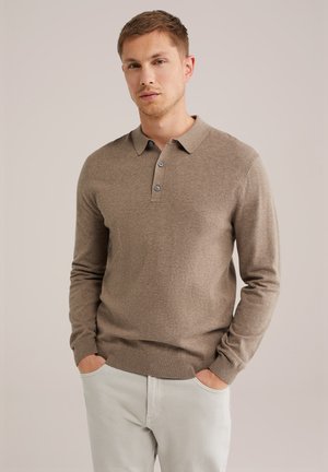 Suéter marrón de cuello, con tapeta de tres botones y mangas largas. Combinado con pantalones de color claro, mostrando una textura suave.