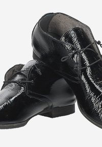 Black patent leather dress shoes with a glossy finish, featuring a round toe, lace-up design, and a low heel. Interior lined with soft material.