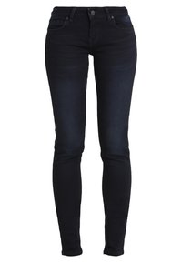 Mörkblå skinny jeans i denim med femfickorsdesign och lätt blekning framtill och baktill. Har bälteslinor och knäppning.